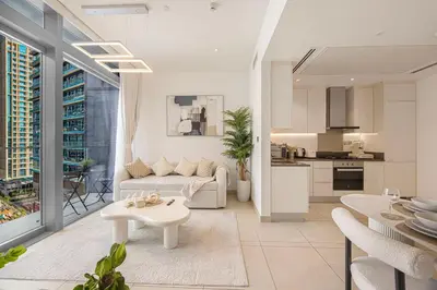 a white living room with a couch and a table at Livin' Holidays - 1 BR - Paradise getaway Dubai Marina in Dubai