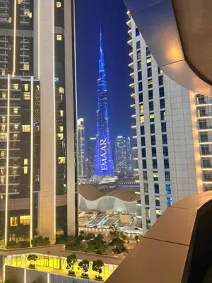 a view of a city skyline at night at Damac Maison Downtown Dubai Luxury 1BR Walk to Dubai Mall in Dubai