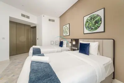 two beds in a hotel room with white at Picture-Perfect Canal and City Views, Minutes from Waterfront Transport, Easy Access to Downtown Delights, Prive by Damac B, Business Bay by Deluxe Holiday Homes in Dubai