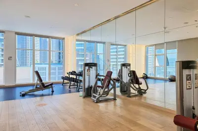 a gym with treadmills and exercise equipment in a building at Picture-Perfect Canal and City Views, Minutes from Waterfront Transport, Easy Access to Downtown Delights, Prive by Damac B, Business Bay by Deluxe Holiday Homes in Dubai