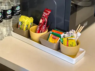 a shelf with three bowls of snacks on a counter at Luxury 1BR Downtown, Pool, Gym, Opera District in Dubai