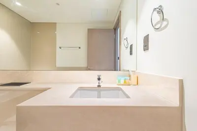 a bathroom with a sink and a mirror at Luxury 1BR Downtown, Pool, Gym, Opera District in Dubai