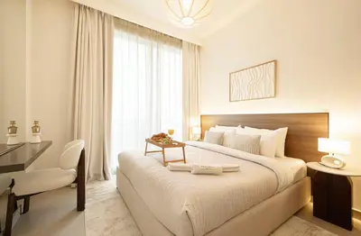 a bedroom with a large bed with a desk and a desk at the space in Dubai