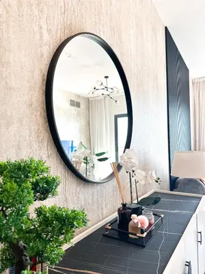 a mirror on the wall of a bathroom with a table at Stunning 1 Bed Large Luxury Apt with Pool View Al Barari by Luxaura in Dubai