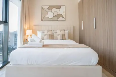 a large white bed in a room with a window at Airstay - Bright Top-Floor 1BR - Azizi Riviera 8 - Monthly Offer Available! in Dubai