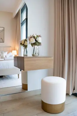 a bedroom with a bed and a table with flowers on it at Airstay - Bright Top-Floor 1BR - Azizi Riviera 8 - Monthly Offer Available! in Dubai