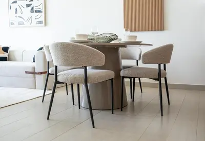 a dining room table with four chairs and a table at Modern 1 Bed Apartment in Binghatti Orchid in Dubai