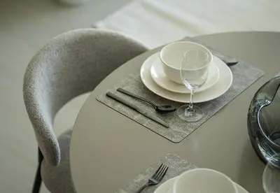 a table with a plate and a wine glass on it at Modern 1 Bed Apartment in Binghatti Orchid in Dubai