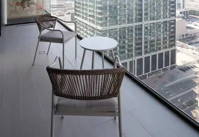 a table and two chairs sitting on a balcony at Modern 1 Bed Apartment in Binghatti Orchid in Dubai