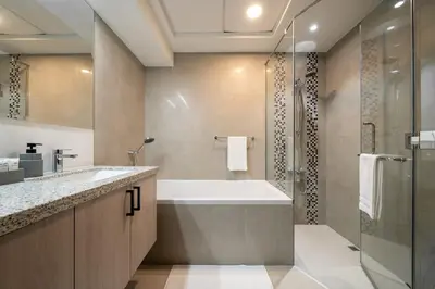 a bathroom with a tub and a shower and a sink at Elegant 3 BR - Stunning Burj Khalifa Views in Dubai