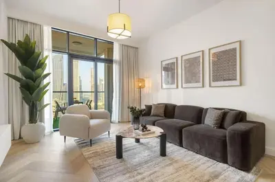 a living room with a couch and a table at Elegant 3 BR - Stunning Burj Khalifa Views in Dubai