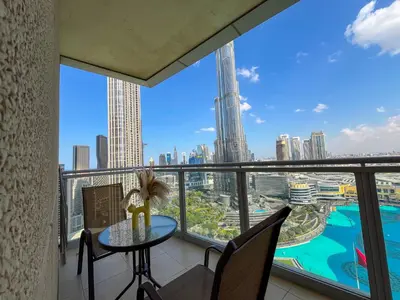 a balcony with a table and chairs and a view of the city at 3BR Luxury Burj Residence Full Burj Khalifa in Dubai