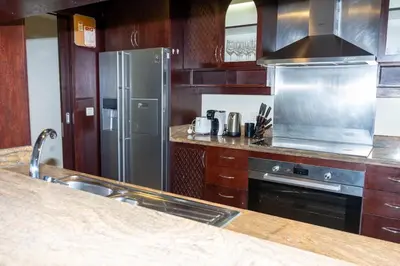 a kitchen with a stainless steel refrigerator and a sink at 3BR Luxury Burj Residence Full Burj Khalifa in Dubai