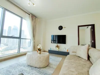 a living room with a couch and a large window at 3BR Luxury Burj Residence Full Burj Khalifa in Dubai