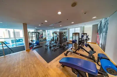 a gym with several treadmills and exercise bikes in it at Prime Location - Dubai Marina 1br - King Size Bed in Dubai