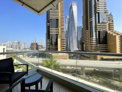 a balcony with chairs and a view of a city at Prime Location - Dubai Marina 1br - King Size Bed in Dubai