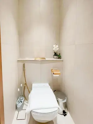 a bathroom with a white toilet and a shelf at Radiant Studio in Binghatti Azure with Pool & Gym in Dubai