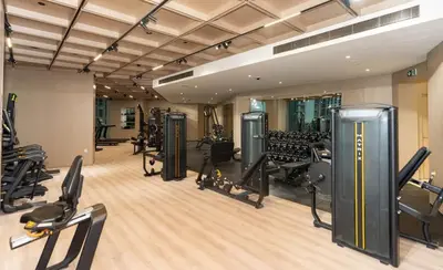 a gym with treadmills and machines in a room at Binghatti Phantom 1BR Luxe Suite with Private Pool in Dubai