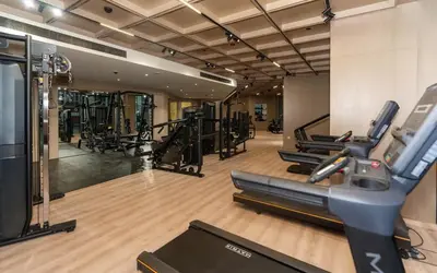 a gym with several treadmills and a treadmill at Binghatti Phantom 1BR Luxe Suite with Private Pool in Dubai