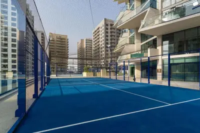 a tennis court in the middle of a building at Airy 1BR Oasis with Plunge Pool in Binghatti Phantom in Dubai