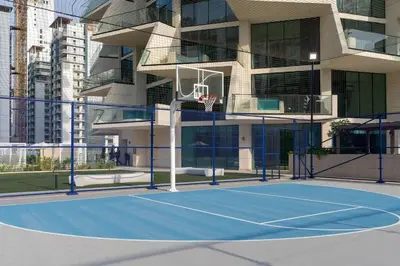 a basketball court in front of a building at Airy 1BR Oasis with Plunge Pool in Binghatti Phantom in Dubai