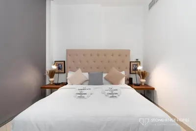 a bedroom with a large white bed with three pillows at Sky-High 3BR in Trident Grand Residence in Dubai Marina & JBR with Epic Sea, Palm & Dubai Eye View in Dubai