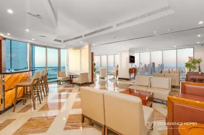 a hotel lobby with a view of the city at Sky-High 3BR in Trident Grand Residence in Dubai Marina & JBR with Epic Sea, Palm & Dubai Eye View in Dubai