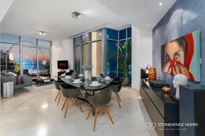 a dining room with a table and a painting on the wall at Sky-High 3BR in Trident Grand Residence in Dubai Marina & JBR with Epic Sea, Palm & Dubai Eye View in Dubai