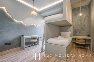 a small bedroom with a bunk bed and a desk at LUX The Contemporary Marina View Suite 7 in Dubai