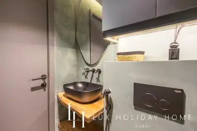 a bathroom with a bowl sink on a counter at LUX The Contemporary Marina View Suite 7 in Dubai