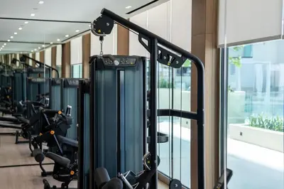 a gym with rows of treadmills and machines at Beautifully Furnished Studio in Binghatti Azure in Dubai