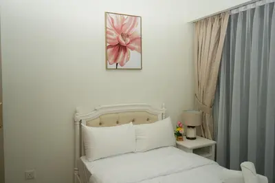 a bedroom with a bed with a pink flower on the wall at 2 Bedroom Luxury In Jaddaf in Dubai