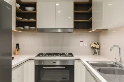 a kitchen with a stove and a sink at 4-BR Luxury Retreat with Iconic Burj Khalifa View in Dubai