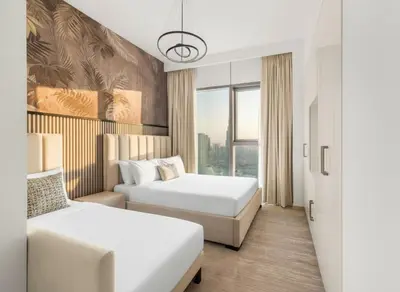 a hotel room with two beds and a window at 4-BR Luxury Retreat with Iconic Burj Khalifa View in Dubai