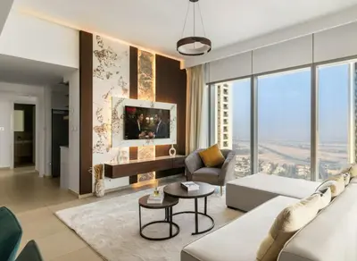 a living room with a couch and a table at 4-BR Luxury Retreat with Iconic Burj Khalifa View in Dubai