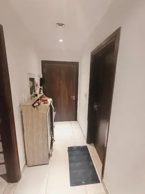a room with a hallway with a door and a rug at Furnished 2 Bedroom Apartment with Balconies in Dubai