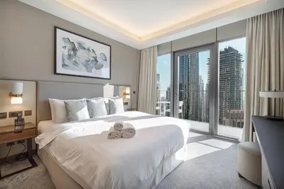 a hotel room with a bed with a teddy bear on it at Address Opera by NAMUVE in Dubai