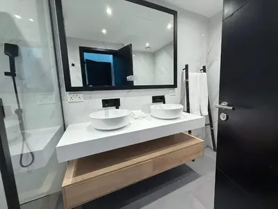 a bathroom with two sinks and a large mirror at Luxury Upgraded 2BR in Dubai Marina in Dubai