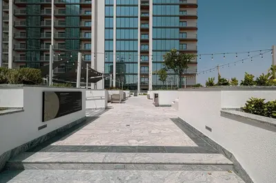 a walkway in a city with tall buildings at Modern 2 Bedroom Apartment in Sobha Hartland in Dubai