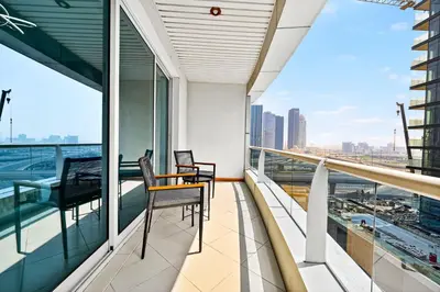 a balcony with two chairs and a view of the city at Chic 1BR Dubai Marina, 5 Min Walk JBR Beach, Metro in Dubai