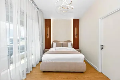 a bedroom with a bed and a large window at Chic 1BR Dubai Marina, 5 Min Walk JBR Beach, Metro in Dubai