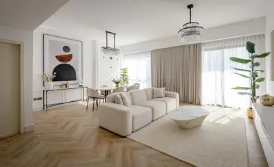 a living room with a white couch and a table at Beautiful 1 bed in JBR! in Dubai