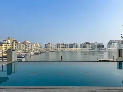 a swimming pool with a view of a river and buildings at Sunny & Stylish 1Bed 7-Min Walk to the Beach! in Dubai