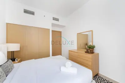 a bedroom with a large white bed and a mirror at Harbour-View 3BR with Assistant Room, Just a Stones Throw from Marine Transportation, Harbour Gate Tower 1, Creek Harbour by Deluxe Holiday Homes in Dubai