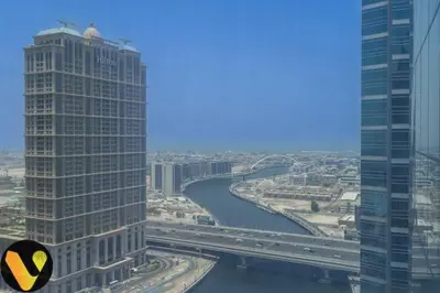 a view of a city with a river and buildings at Vogue Business Bay Court Tower close to Downtown Burj Khalifa and Dubai Mall, Studio Apartment with Canal view in Dubai