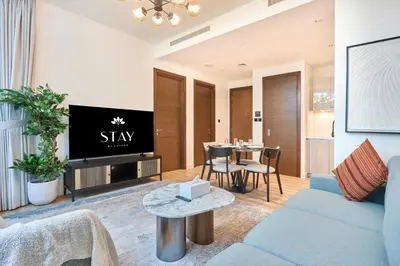 a living room with a blue couch and a tv at STAY BY LATINEM Luxury 1BR Holiday Home CD 0602 Near Burj Khalifa in Dubai