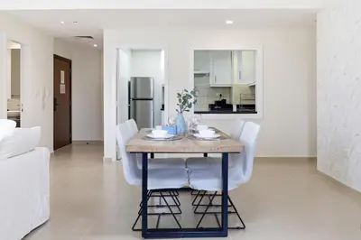 a kitchen and dining room with a table and chairs at Rimal 1, JBR - 2 Bedroom Apartment - Allsopp & Allsopp in Dubai