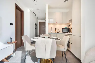a kitchen and dining room with a table and chairs at STAY BY LATINEM Luxury 1BR Holiday Home CC 0302 Near Burj Khalifa in Dubai