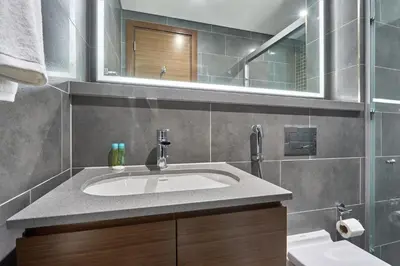 a bathroom with a sink and a mirror at STAY BY LATINEM Luxury 1BR Holiday Home CC 0302 Near Burj Khalifa in Dubai