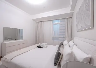 a white bedroom with a bed and a television at StayShort - 2 Bedroom in Dubai Marina with Huge Balcony in Dubai